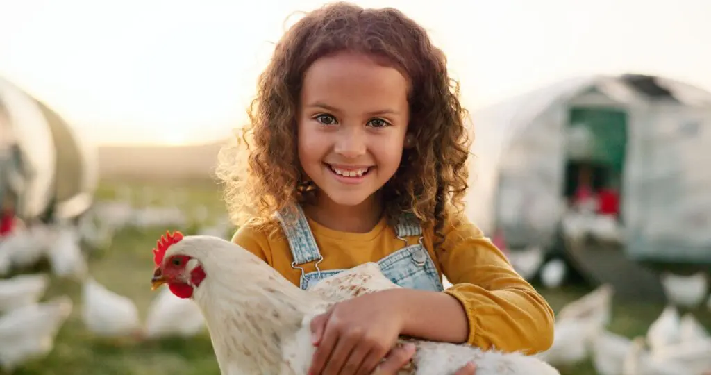 Girl learns about farming and has fun with chickens!